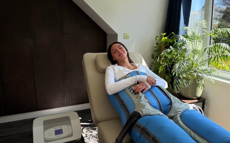 A client relaxing in compression garments during lymphatic drainage