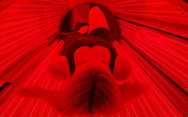 A client inside the full-body red light bed